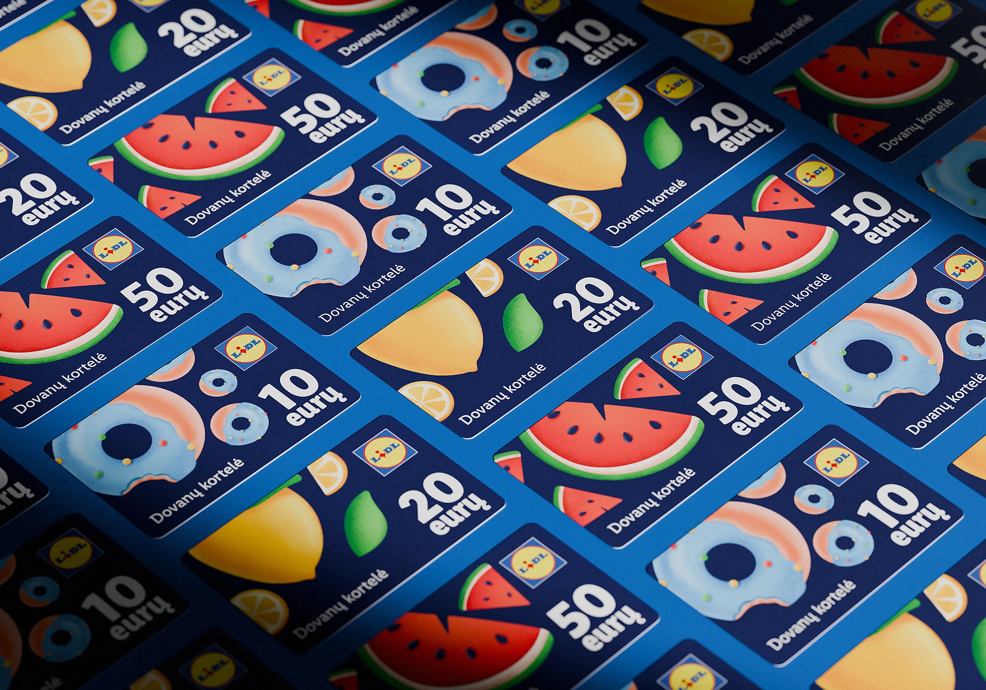 Pattern of Lidl gift cards arranged in a grid on a blue surface. Each card features a bold fruit or donut illustration, displays the value in euros (10, 20, or 50), and includes the Lithuanian phrase “Dovanų kortelė.”