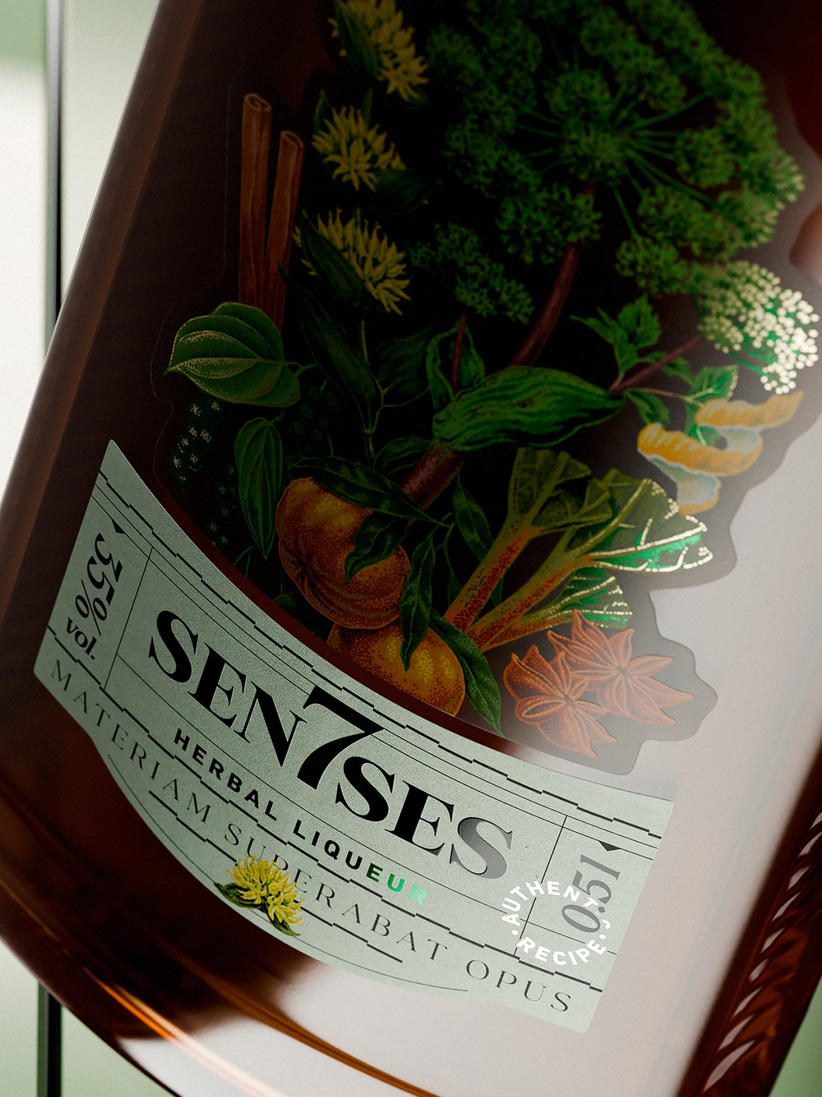 Front label of a 7Senses Herbal Liqueur bottle, shown in close-up on amber glass, featuring detailed botanical illustrations of herbs, spices, and fruits with subtle metallic accents, paired with a curved pale label reading “SEN7SES” and “Herbal Liqueur,” photographed with soft light and shallow depth of field.