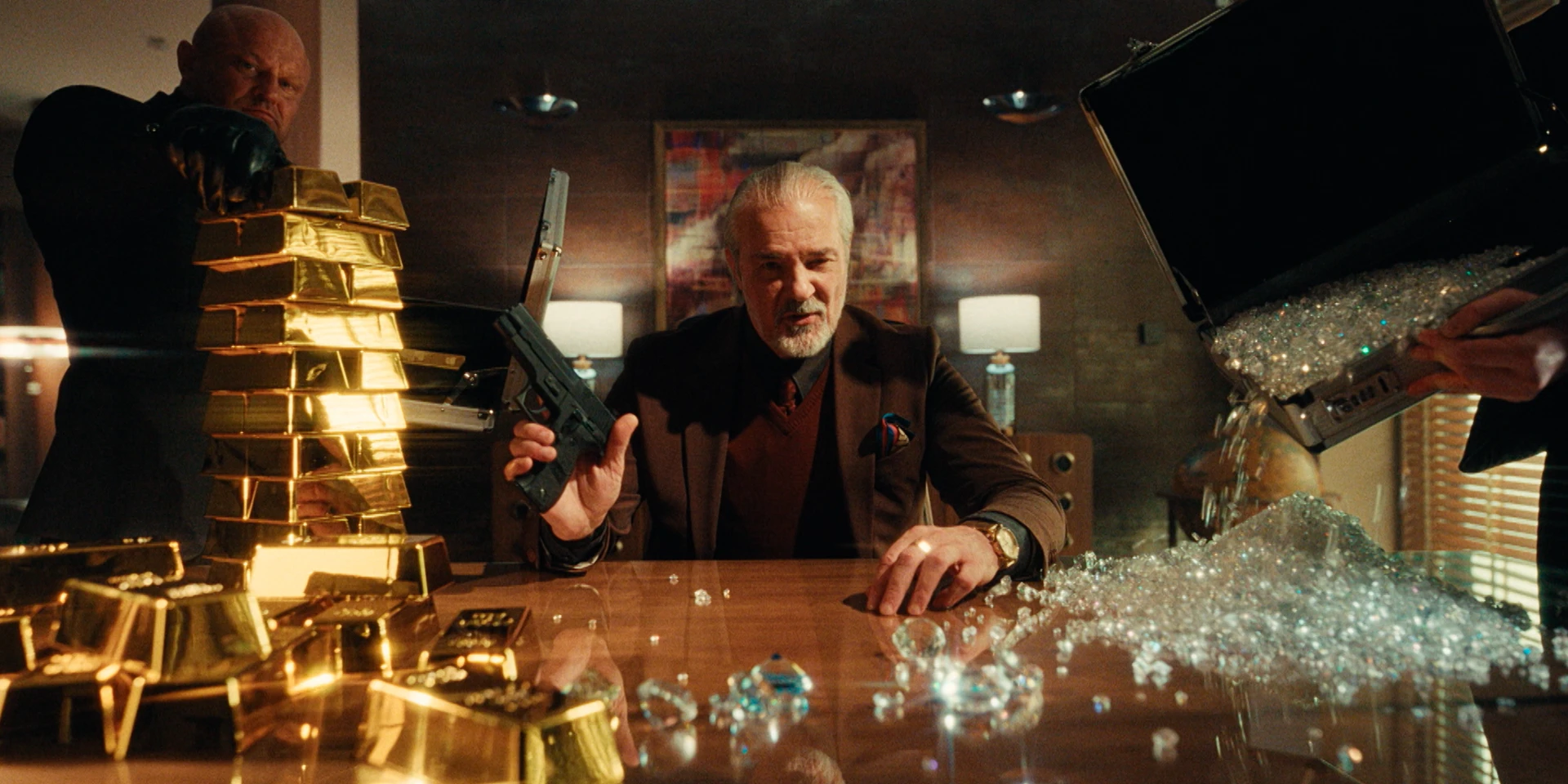 Cinematic scene of a wealthy crime boss seated at a polished wooden table, holding a handgun while gold bars are stacked on one side and a briefcase spills diamonds onto the surface, with two bodyguards standing nearby in a dimly lit office interior.